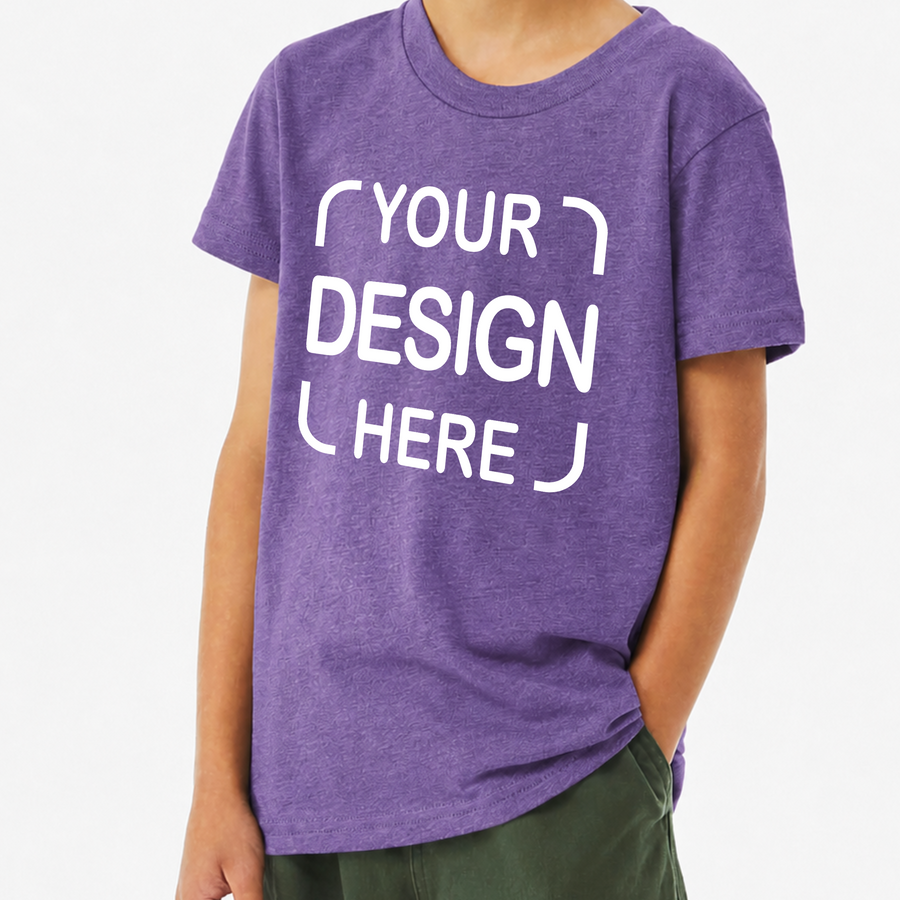 A child wearing a heather purple short-sleeve t-shirt with white placeholder text reading 'YOUR DESIGN HERE' on the front