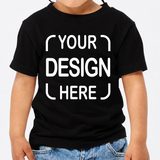 A child wearing a black short-sleeve T-shirt with large white placeholder text reading 'YOUR DESIGN HERE' on the front