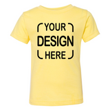 A pale yellow short-sleeve t-shirt with black placeholder text reading 'YOUR DESIGN HERE' printed on the front