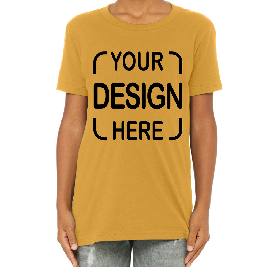 A person wearing a mustard yellow short-sleeve t-shirt with black placeholder text reading 'YOUR DESIGN HERE' on the front