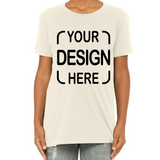 A person wearing a cream-colored short-sleeve t-shirt with black placeholder text reading 'YOUR DESIGN HERE' on the front