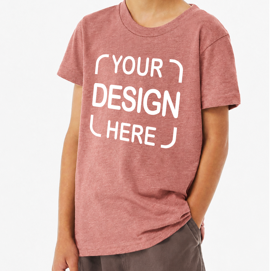 A person wearing a heathered dusty rose short-sleeve t-shirt with white placeholder text reading 'YOUR DESIGN HERE' on the front