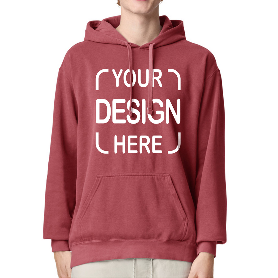 A person wearing a dusty rose red pullover hoodie with a white customizable graphic print that reads 'YOUR DESIGN HERE' on the front.